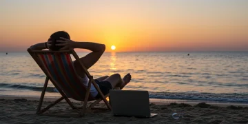 Serene beach sunset with person relaxing, symbolizing maximized holiday PTO for work-life balance and rejuvenation in late 2025.